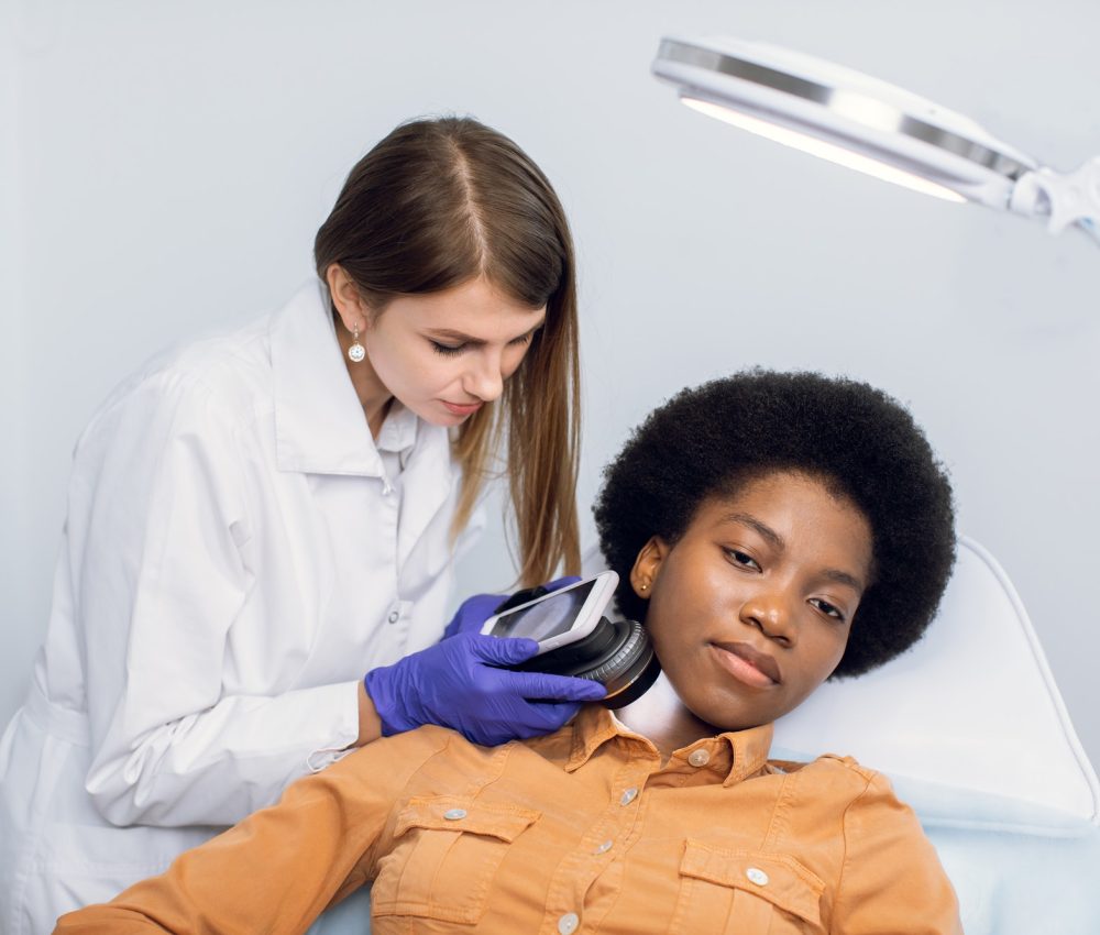 young-african-american-woman-client-lying-on-the-couch-in-modern-dermatology-clinic-having-face.jpg